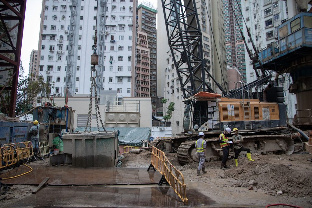 An active construction site with covered trenches
