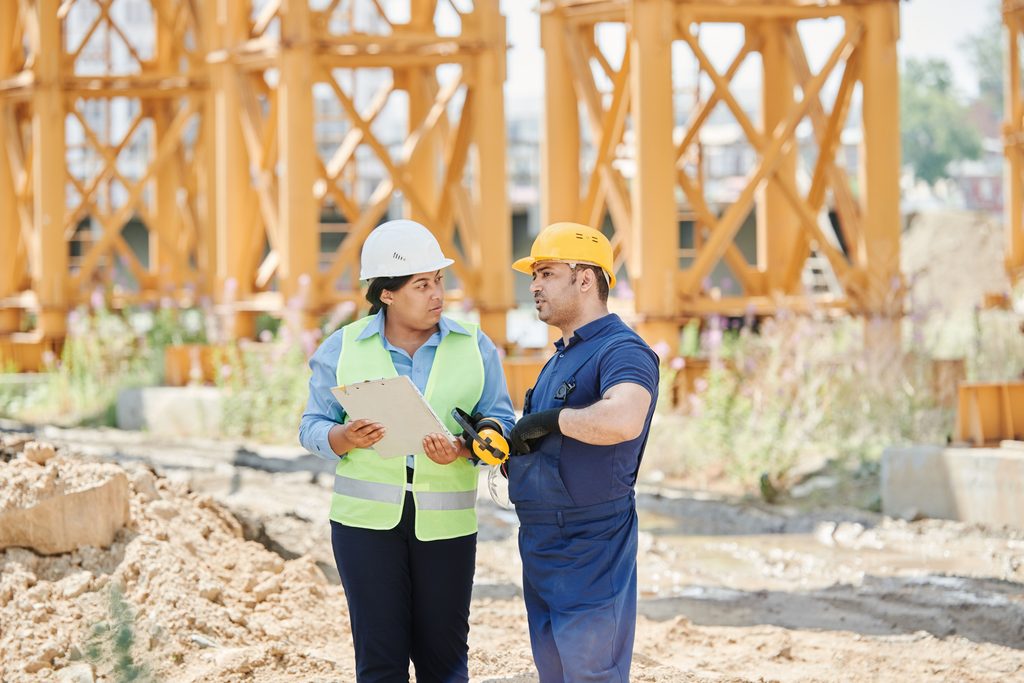 construction workers conducting a site inspection to ensure safety compliance