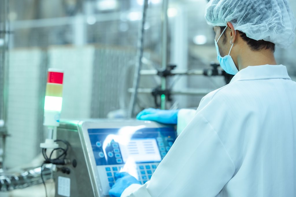 Operator adjusting production settings during snack commercialization trials